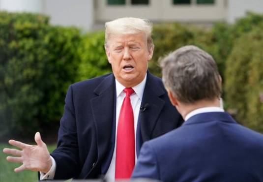US President Donald Trump (L) speaks with anchor Bill Hemmer during a Fox News virtual town hall meeting from the Rose Garden of the White House in Washington, DC, on March 24, 2020. (Photo by MANDEL NGAN / AFP)