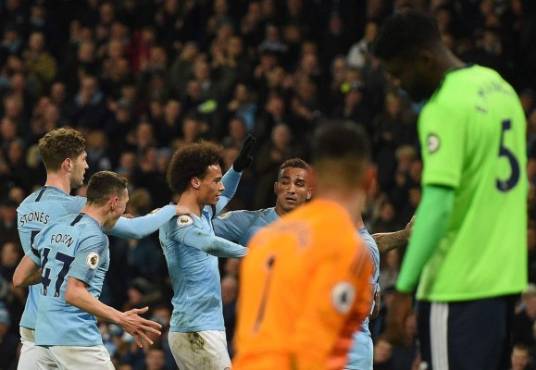 Manchester City's German midfielder Leroy Sane (C) celebrates scoring his team's second goal during the English Premier League football match between Manchester City and Cardiff City at the Etihad Stadium in Manchester, north west England, on April 3, 2019. (Photo by Oli SCARFF / AFP) / RESTRICTED TO EDITORIAL USE. No use with unauthorized audio, video, data, fixture lists, club/league logos or 'live' services. Online in-match use limited to 120 images. An additional 40 images may be used in extra time. No video emulation. Social media in-match use limited to 120 images. An additional 40 images may be used in extra time. No use in betting publications, games or single club/league/player publications. /