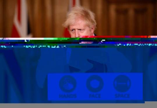 Britain's Prime Minister Boris Johnson leaves after attending a virtual press conference inside 10 Downing Street in central London on December 21, 2020, after a string of countries banned travellers and all but unaccompanied freight arriving from the UK, due to the rapid spread of a new, more-infectious coronavirus strain. - Countries around the world closed their borders to Britain Monday in a race to contain a fast-spreading variant of the coronavirus as the European Union neared approval of its first jab for the bloc's vaccination campaign. British Prime Minister Boris Johnson held a crisis meeting about the situation Monday, with particular concern about the disruption of goods from France, which imposed a 48-hour blockade on people and lorries crossing the English Channel. (Photo by Tolga Akmen / POOL / AFP)