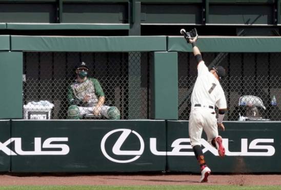 SAN FRANCISCO, CALIFORNIA - AUGUST 16: Mauricio Dubon #1 of the San Francisco Giants watches the ball go over his head for a two-run RBI triple off the bat of Mark Canha #20 of the Oakland Athletics in the top of the fifth inning at Oracle Park on August 16, 2020 in San Francisco, California. Thearon W. Henderson/Getty Images/AFP