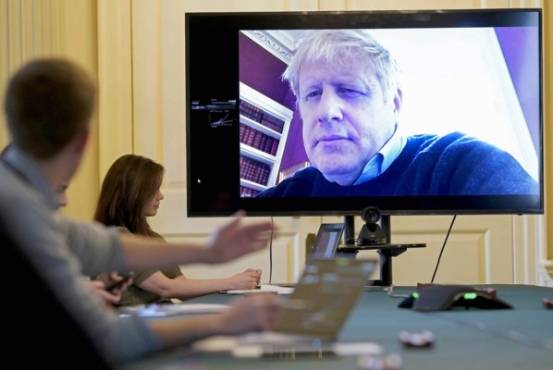 (FILES) In this file photo taken on March 28, 2020 A handout picture released by 10 Downing Street, the office of the British prime minister on March 28, 2020, shows an image of Britain's Prime Minister Boris Johnson on a screen as he remotely chairs the morning novel coronavirus Covid-19 meeting by video link, in Downing Street in central London. - British Prime Minister Boris Johnson was taken to hospital on April 5, 2020 for tests, his office said, 10 days after he tested positive for coronavirus. Johnson, 55, announced he had mild symptoms of COVID-19 on March 27 and had been in self-isolation at his Downing Street residence for seven days. (Photo by Andrew PARSONS / 10 Downing Street / AFP) / RESTRICTED TO EDITORIAL USE - MANDATORY CREDIT 'AFP PHOTO / 10 DOWNING STREET / ANDREW PARSONS / HANDOUT' - NO MARKETING - NO ADVERTISING CAMPAIGNS - DISTRIBUTED AS A SERVICE TO CLIENTS