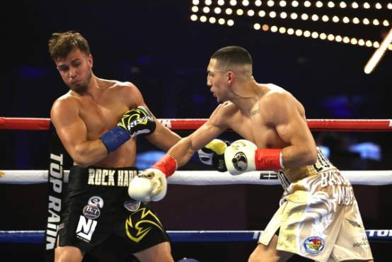 NEW YORK, NEW YORK - DECEMBER 08: Teofimo Lopez punches Mason Menard in the first round during their lightweight fight at The Hulu Theater at Madison Square Garden on December 08, 2018 in New York City. Al Bello/Getty Images/AFP