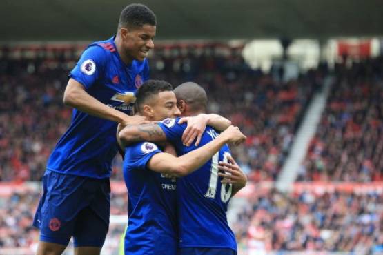 Manchester United's English midfielder Jesse Lingard (C) celebrates with Manchester United's English midfielder Ashley Young (R) and Manchester United's English striker Marcus Rashford (L) after scoring their second goal during the English Premier League football match between Middlesbrough and Manchester United at Riverside Stadium in Middlesbrough, north east England on March 19, 2017. / AFP PHOTO / Lindsey PARNABY / RESTRICTED TO EDITORIAL USE. No use with unauthorized audio, video, data, fixture lists, club/league logos or 'live' services. Online in-match use limited to 75 images, no video emulation. No use in betting, games or single club/league/player publications. /
