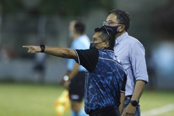 Salomón Nazar dirigiendo en la Liga Nacional mientras dialoga con su preparador físico Henry Oliva.
