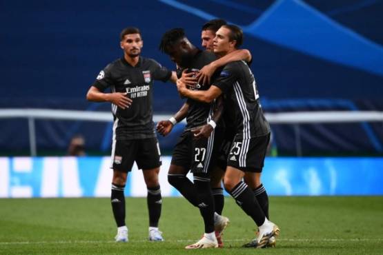 Lyon's Ivorian forward Maxwel Cornet (2L) celebrates his goal during the UEFA Champions League quarter-final football match between Manchester City and Lyon at the Jose Alvalade stadium in Lisbon on August 15, 2020. (Photo by FRANCK FIFE / POOL / AFP)