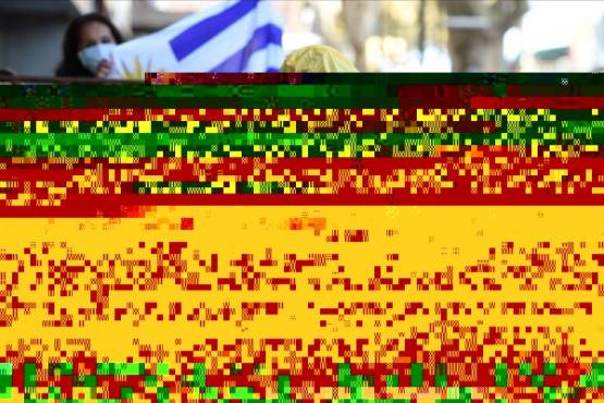 In this picture released by Adhoc news agency a crew member of the Greg Mortimer cruise liner arrives at a hotel in Montevideo on May 12, 2020. - More than 60 crew members from the coronavirus-hit cruise ship Greg Mortimer -- among them dozens ill with COVID-19 -- were allowed on Tuesday to disembark in Uruguay to quarantine in two hotels. (Photo by Daniel Rodriguez / adhoc / AFP) / Uruguay OUT / RESTRICTED TO EDITORIAL USE - MANDATORY CREDIT 'AFP PHOTO/ ADHOC / Daniel RODRIGUEZ ' - NO MARKETING NO ADVERTISING CAMPAIGNS - DISTRIBUTED AS A SERVICE TO CLIENTS