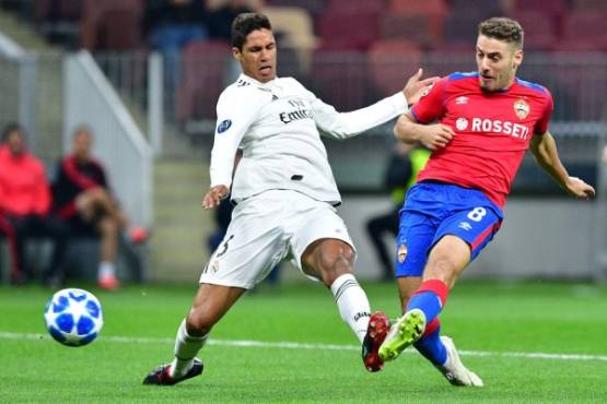 CSKA Moscow's Croatian midfielder Nikola Vlasic shoots to score the opening goal next to Real Madrid's French defender Raphael Varane during the UEFA Champions League group G football match between PFC CSKA Moscow and Real Madrid CF at the Luzhniki stadium in Moscow on October 2, 2018. / AFP PHOTO / Mladen ANTONOV
