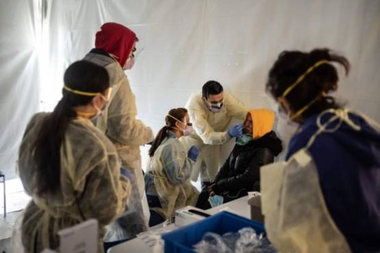 NEW YORK, NY - MARCH 24: Doctors test hospital staff with flu-like symptoms for coronavirus (COVID-19) in set-up tents to triage possible COVID-19 patients outside before they enter the main Emergency department area at St. Barnabas hospital in the Bronx on March 24, 2020 in New York City. New York City has about a third of the nations confirmed coronavirus cases, making it the center of the outbreak in the United States. Misha Friedman/Getty Images/AFP