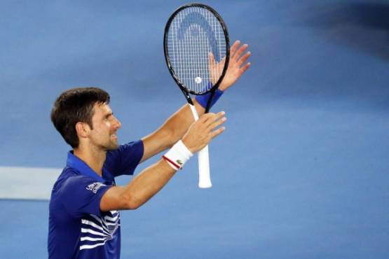 Serbia's Novak Djokovic celebrates his victory against France's Jo-Wilfried Tsonga during their men's singles match on day four of the Australian Open tennis tournament in Melbourne early January 18, 2019. (Photo by DAVID GRAY / AFP) / -- IMAGE RESTRICTED TO EDITORIAL USE - STRICTLY NO COMMERCIAL USE --