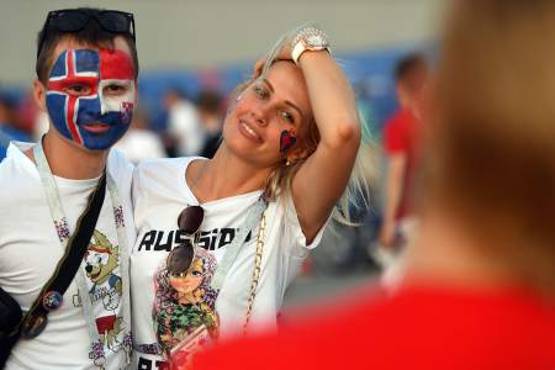 A fan with half his face painted with the Icelandic flag and the other half with the Croatian one poses with another fan before the Russia 2018 World Cup Group D football match between Iceland and Croatia at the Rostov Arena in Rostov-On-Don on June 26, 2018. / AFP PHOTO / Khaled DESOUKI / RESTRICTED TO EDITORIAL USE - NO MOBILE PUSH ALERTS/DOWNLOADS