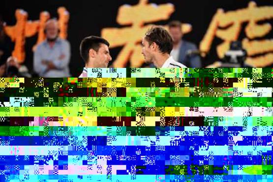 Serbia's Novak Djokovic (L) and Russia's Daniil Medvedev greet each other after their men's singles final match on day fourteen of the Australian Open tennis tournament in Melbourne on February 21, 2021. (Photo by Paul CROCK / AFP) / -- IMAGE RESTRICTED TO EDITORIAL USE - STRICTLY NO COMMERCIAL USE --