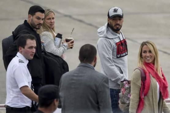 Uruguayan Luis Suarez (2-R), footballer of Spanish team Barcelona, and his wife Sofia Balbi (R) arrive at Rosario's airport, Santa Fe Province, Argentina on June 29, 2017 to attend the wedding of Argentine football star and player of Spanish Barcelona, Lionel Messi, on Friday.Football and showbiz stars started gathering in Rosario for Latin America's celebrity wedding bash of the decade when Barcelona superstar Lionel Messi marries his childhood sweetheart Antonella Roccuzzo on June 30. / AFP PHOTO / Eitan ABRAMOVICH