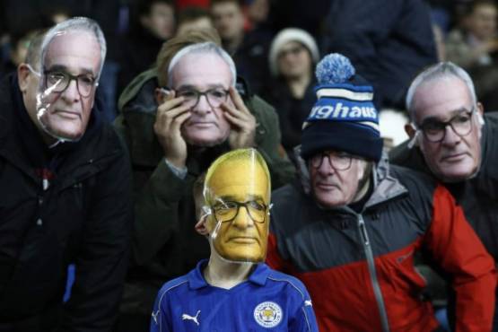 Fans are pictured wearing masks of Leicester City's Italian former manager Claudio Ranieri before the English Premier League football match between Leicester City and Liverpool at King Power Stadium in Leicester, central England on February 27, 2017. / AFP PHOTO / ADRIAN DENNIS / RESTRICTED TO EDITORIAL USE. No use with unauthorized audio, video, data, fixture lists, club/league logos or 'live' services. Online in-match use limited to 75 images, no video emulation. No use in betting, games or single club/league/player publications. /