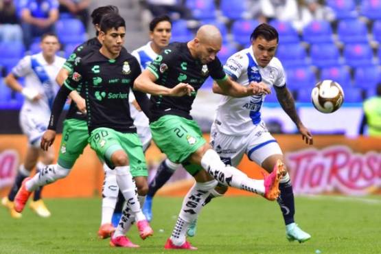 Christian Tabo (R) of Puebla vies for the ball with Matheus Doria of Santos during their second leg semifinal Mexican Clausura 2021 tournament at the Cuauhtemoc stadium in Puebla, Puebla state, Mexico on May 23, 2021. (Photo by HECTOR HERNANDEZ / AFP)