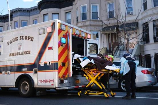 NEW YORK, NY - APRIL 11: Health workers carry a patient to an ambulance on April 11, 2020 in the Brooklyn borough of New York City. According to John Hopkins University, the global death toll from COVID-19 has now reached 100,000 worldwide with many experts believing that the number is actually higher. Spencer Platt/Getty Images/AFP
