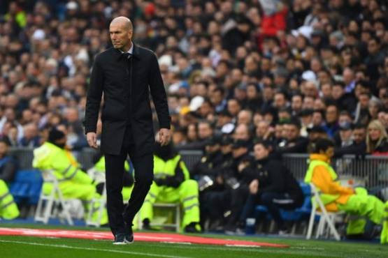 Real Madrid's French coach Zinedine Zidane walks on the sideline during the Spanish league football match between Real Madrid CF and Sevilla FC at the Santiago Bernabeu stadium in Madrid on January 18, 2020. (Photo by GABRIEL BOUYS / AFP)