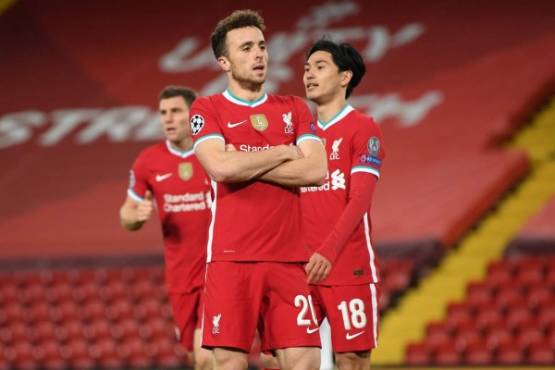Liverpool's Portuguese striker Diogo Jota (C) celebrates after scoring the opening goal during the UEFA Champions league Group D football match between Liverpool and Midtjylland at Anfield in Liverpool, north west England on October 27, 2020. (Photo by Michael Regan / POOL / AFP)