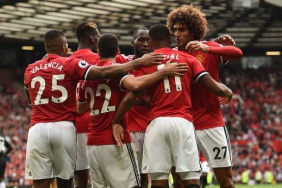 Manchester United's French striker Anthony Martial (2nd R) celebrates with teammates after scoring their third goal during the English Premier League football match between Manchester United and West Ham United at Old Trafford in Manchester, north west England, on August 13, 2017.Manchester United won the game 4-0. / AFP PHOTO / Oli SCARFF / RESTRICTED TO EDITORIAL USE. No use with unauthorized audio, video, data, fixture lists, club/league logos or 'live' services. Online in-match use limited to 75 images, no video emulation. No use in betting, games or single club/league/player publications. /