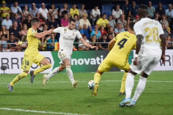 Real Madrid's Welsh forward Gareth Bale (2L) scores a goal during the Spanish league football match Villarreal CF against Real Madrid CF at La Ceramica stadium in Vila-real on September 1, 2019. (Photo by Josep LAGO / AFP)