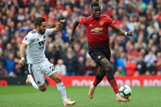 Wolverhampton Wanderers' Portuguese midfielder Joao Moutinho (L) vies with Manchester United's French midfielder Paul Pogba during the English Premier League football match between Manchester United and Wolverhampton Wanderers at Old Trafford in Manchester, north west England, on September 22, 2018. / AFP PHOTO / Lindsey PARNABY / RESTRICTED TO EDITORIAL USE. No use with unauthorized audio, video, data, fixture lists, club/league logos or 'live' services. Online in-match use limited to 120 images. An additional 40 images may be used in extra time. No video emulation. Social media in-match use limited to 120 images. An additional 40 images may be used in extra time. No use in betting publications, games or single club/league/player publications. /