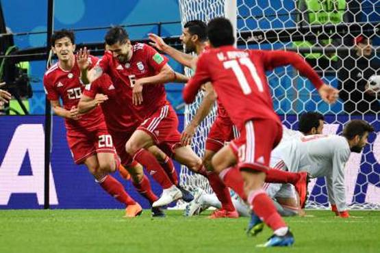 Iran's midfielder Saeid Ezatolahi (2nd-L) runs to celebrate a goal, that was ruled offside, during the Russia 2018 World Cup Group B football match between Iran and Spain at the Kazan Arena in Kazan on June 20, 2018. / AFP PHOTO / SAEED KHAN / RESTRICTED TO EDITORIAL USE - NO MOBILE PUSH ALERTS/DOWNLOADS