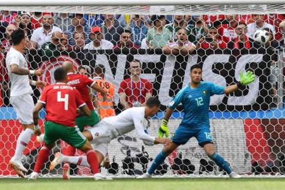 Portugal's forward Cristiano Ronaldo scores a header during the Russia 2018 World Cup Group B football match between Portugal and Morocco at the Luzhniki Stadium in Moscow on June 20, 2018. / AFP PHOTO / Yuri CORTEZ / RESTRICTED TO EDITORIAL USE - NO MOBILE PUSH ALERTS/DOWNLOADS