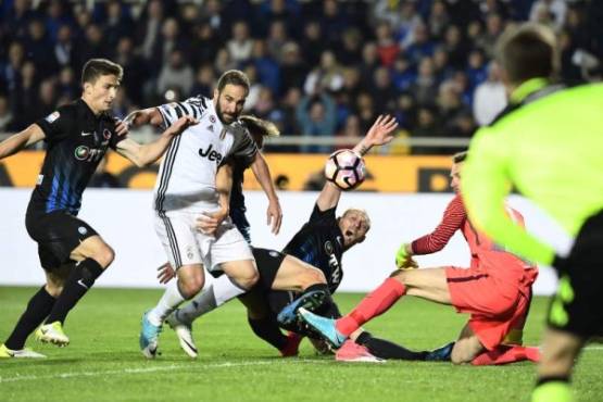 Juventus' Argentinian forward Gonzalo Gerardo Higuain (2ndL) vies with Atalanta players during the Italian Serie A football match Atalanta vs Juventus at the 'Atleti Azzurri d'Italia' stadium in Bergamo on April 28, 2017. / AFP PHOTO / MIGUEL MEDINA