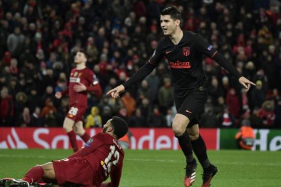 Atletico Madrid's Spanish striker Alvaro Morata celebrates scoring his team's third goal during the UEFA Champions league Round of 16 second leg football match between Liverpool and Atletico Madrid at Anfield in Liverpool, north west England on March 11, 2020. (Photo by JAVIER SORIANO / AFP)