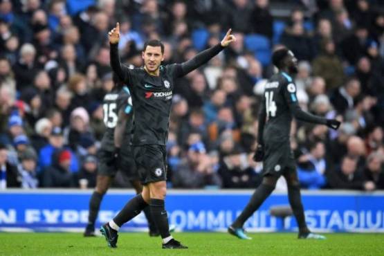 Chelsea's Belgian midfielder Eden Hazard celebrates after scoring their third goal during the English Premier League football match between Brighton and Hove Albion and Chelsea at the American Express Community Stadium in Brighton, southern England on January 20, 2018. / AFP PHOTO / Glyn KIRK / RESTRICTED TO EDITORIAL USE. No use with unauthorized audio, video, data, fixture lists, club/league logos or 'live' services. Online in-match use limited to 75 images, no video emulation. No use in betting, games or single club/league/player publications. /