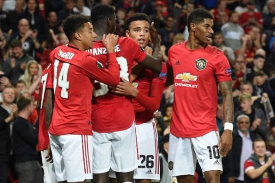 Manchester United's striker Mason Greenwood (C) celebrates with teammates after scoring the opening goal of the UEFA Europa League Group L football match between Manchester United and Astana at Old Trafford in Manchester, north west England, on September 19, 2019. (Photo by Oli SCARFF / AFP)
