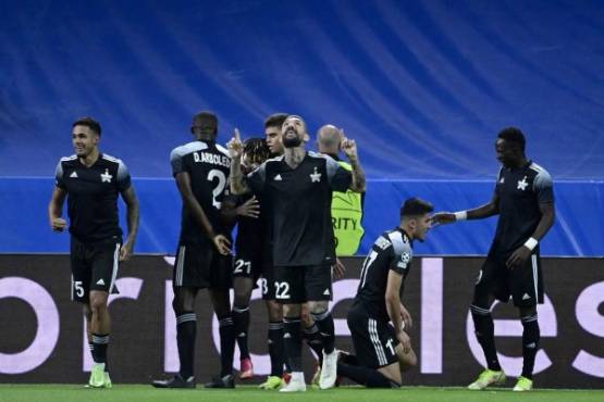 Sheriff's Uzbek forward Jasurbek Yakhshiboev (2R) celebrates his goal with his teammates during the UEFA Champions League first round group D footbal match between Real Madrid and Sheriff Tiraspol at the Santiago Bernabeu stadium in Madrid, on September 28, 2021. (Photo by JAVIER SORIANO / AFP)