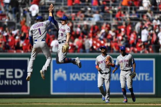 WASHINGTON, DC - MARCH 28: Amed Rosario #1 and Brandon Nimmo #9 of the New York Mets celebrate after the Mets defeated the Washington Nationals 2-0 on Opening Day at Nationals Park on March 28, 2019 in Washington, DC. Patrick McDermott/Getty Images/AFP