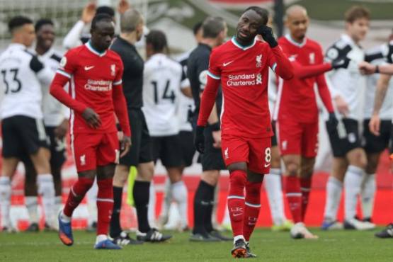Liverpool's Guinean midfielder Naby Keita (centre right) reacts to their defeat on the final whistle in the English Premier League football match between Liverpool and Fulham at Anfield in Liverpool, north west England on March 7, 2021. - Fulham won the game 1-0. (Photo by Clive Brunskill / POOL / AFP) / RESTRICTED TO EDITORIAL USE. No use with unauthorized audio, video, data, fixture lists, club/league logos or 'live' services. Online in-match use limited to 120 images. An additional 40 images may be used in extra time. No video emulation. Social media in-match use limited to 120 images. An additional 40 images may be used in extra time. No use in betting publications, games or single club/league/player publications. /