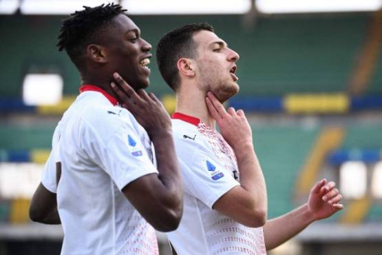 AC Milan's Portuguese defender Diogo Dalot celebrates after scoring with AC Milan's Portuguese forward Rafael Leao (L) during the Italian Serie A football match Hellas Verona vs AC Milan played behind closed doors at the Marcantonio Bentegodi Stadium in Verona on March 7, 2021. (Photo by MARCO BERTORELLO / AFP)