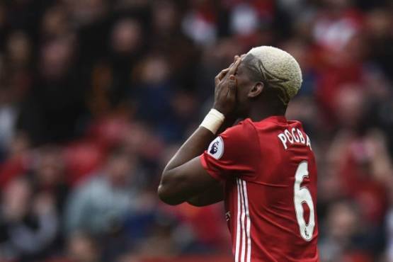 Manchester United's French midfielder Paul Pogba reacts after failing to convert a late chance during the English Premier League football match between Manchester United and Bournemouth at Old Trafford in Manchester, north west England, on March 4, 2017.The game finished 1-1. / AFP PHOTO / Oli SCARFF / RESTRICTED TO EDITORIAL USE. No use with unauthorized audio, video, data, fixture lists, club/league logos or 'live' services. Online in-match use limited to 75 images, no video emulation. No use in betting, games or single club/league/player publications. /