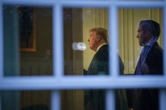 WASHINGTON, DC - APRIL 22: U.S. President Donald Trump stands with staff following the daily coronavirus task force briefing at the White House on April 22, 2020 in Washington, DC. The House is set to vote Thursday on an interim round of coronavirus aid for small businesses, as Democrats sought to include an additional $150 billion in funding for state and local budgets. Drew Angerer/Getty Images/AFP