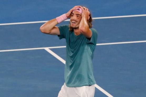 Greece's Stefanos Tsitsipas celebrates his victory against Switzerland's Roger Federer during their men's singles match on day seven of the Australian Open tennis tournament in Melbourne on January 20, 2019. (Photo by DAVID GRAY / AFP) / -- IMAGE RESTRICTED TO EDITORIAL USE - STRICTLY NO COMMERCIAL USE --