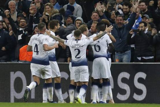 Tottenham Hotspur's English striker Harry Kane is mobbed as he celebrates scoring his team's second goal during the UEFA Champions League group B football match between Tottenham Hotspur and PSV Eindhoven at Wembley Stadium in London, on November 6, 2018. - Tottenham won the match 2-1. (Photo by Ian KINGTON / IKIMAGES / AFP)