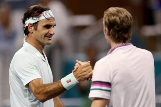 MIAMI GARDENS, FLORIDA - MARCH 29: Roger Federer of Switzerland is congratulated by Denis Shapovalov of Canada after their match during the men's semifinals of the Miami Open Presented by Itau at Hard Rock Stadium March 29, 2019 in Miami Gardens, Florida. Matthew Stockman/Getty Images/AFP