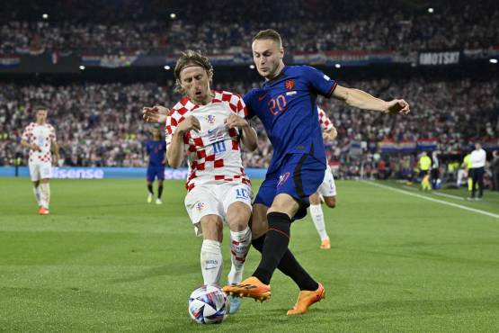 Croatia's midfielder Luka Modric (L) and Netherlands' midfielder Teun Koopmeiners (R) fight for the ball during the UEFA Nations League semi final football match between The Netherlands and Croatia at the De Kuip Stadium in Rotterdam on June 14, 2023. (Photo by JOHN THYS / AFP)