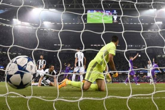 Juventus' Italian goalkeeper Gianluigi Buffon fails to stop a goal during the UEFA Champions League final football match between Juventus and Real Madrid at The Principality Stadium in Cardiff, south Wales, on June 3, 2017. / AFP PHOTO / Filippo MONTEFORTE