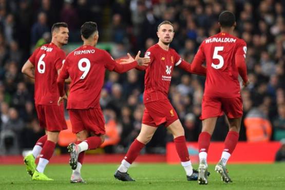 Liverpool's English midfielder Jordan Henderson (C) celebrates after scoring during the English Premier League football match between Liverpool and Tottenham Hotspur at Anfield in Liverpool, north west England on October 27, 2019. (Photo by Paul ELLIS / AFP) / RESTRICTED TO EDITORIAL USE. No use with unauthorized audio, video, data, fixture lists, club/league logos or 'live' services. Online in-match use limited to 120 images. An additional 40 images may be used in extra time. No video emulation. Social media in-match use limited to 120 images. An additional 40 images may be used in extra time. No use in betting publications, games or single club/league/player publications. /