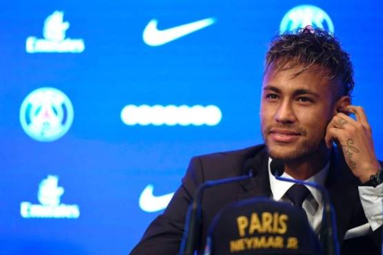 Brazilian superstar Neymar listens during a press conference at the Parc des Princes stadium on August 4, 2017 in Paris after agreeing a five-year contract following his world record 222 million euro ($260 million) transfer from Barcelona to Paris Saint-Germain.Paris Saint-Germain have signed Brazilian forward Neymar from Barcelona for a world-record transfer fee of 222 million euros (around $264 million), more than doubling the previous record. Neymar said he came to Paris Saint-Germain for a 'bigger challenge' in his first public comments since arriving in the French capital. / AFP PHOTO / Lionel BONAVENTURE