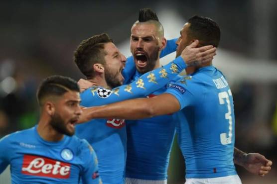 Napoli's forward from Belgium Dries Mertens (L) celebrates with teammates Napoli's defender from Algeria Faouzi Ghoulam (R) and Napoli's midfielder from Slovakia Marek Hamsik (C) after scoring during the UEFA Champions League football match SSC Napoli vs Real Madrid on March 7, 2017 at the San Paolo stadium in Naples. / AFP PHOTO / Filippo MONTEFORTE