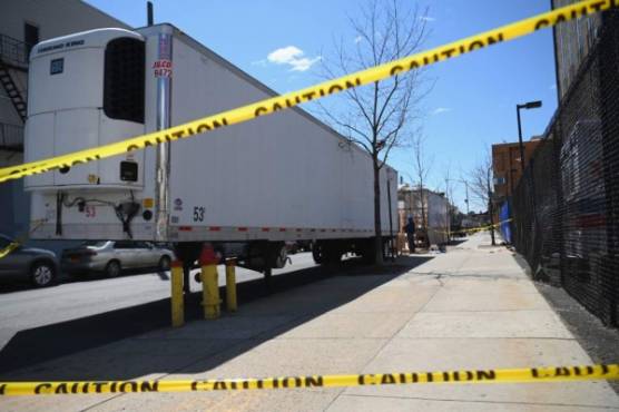 (FILES) In this file photo taken on April 02, 2020, refridgerated trailers are parked outside of the Wyckoff Heights Medical Center in Brooklyn on April 02, 2020 in New York. - New York state's death toll rose to 3,565 on April 4, 2020, Governor Andrew Cuomo said, up from 2,935 the previous day, in the largest 24-hour jump recorded there. The state has now recorded 113,704 positive cases -- 63,306 in New York City -- just 6,000 short of hard-hit Italy's total. (Photo by Angela Weiss / AFP)
