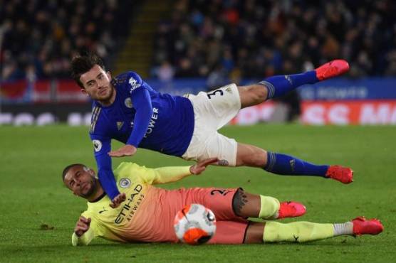 Manchester City's English defender Kyle Walker vies with Leicester City's English defender Ben Chilwell (up) during the English Premier League football match between Leicester City and Manchester City at King Power Stadium in Leicester, central England on February 22, 2020. (Photo by Oli SCARFF / AFP) / RESTRICTED TO EDITORIAL USE. No use with unauthorized audio, video, data, fixture lists, club/league logos or 'live' services. Online in-match use limited to 120 images. An additional 40 images may be used in extra time. No video emulation. Social media in-match use limited to 120 images. An additional 40 images may be used in extra time. No use in betting publications, games or single club/league/player publications. /