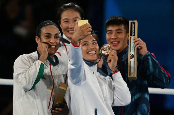 La argelina Imane Khelif posando con la medalla de oro y junto a las otras medallistas en boxeo de los Juegos Olímpicos París 2024.