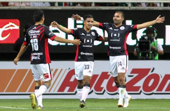 Michaell Chirinos of Lobos BUAP (C) celebrates his goal against Guadalajara during their Mexican Clausura 2019 tournament football match at Akron stadium in Guadalajara, Jalisco State, Mexico, on April 6, 2019. (Photo by Ulises Ruiz / AFP)