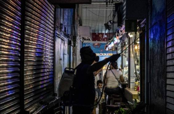 A worker disinfects the central market in the face of the global COVID-19 coronavirus pandemic, in San Jose, Costa Rica, on March 14, 2020. (Photo by Ezequiel BECERRA / AFP)