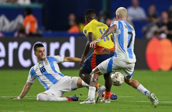 Argentina's midfielder #16 Giovani Lo Celso fights for the ball with Colombia's midfielder #11 Jhon Arias and Argentina's midfielder #07 Rodrigo De Paul during the Conmebol 2024 Copa America tournament final football match between Argentina and Colombia at the Hard Rock Stadium, in Miami, Florida on July 14, 2024. (Photo by Chandan Khanna / AFP)
